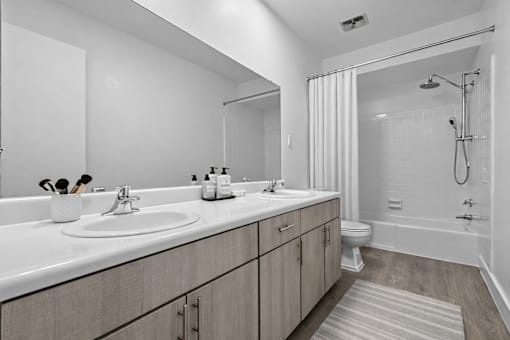 A bathroom with a white sink and a white tub.