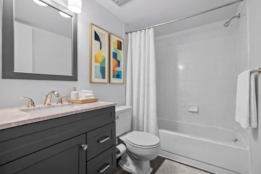 A bathroom with a toilet, sink, and bathtub.