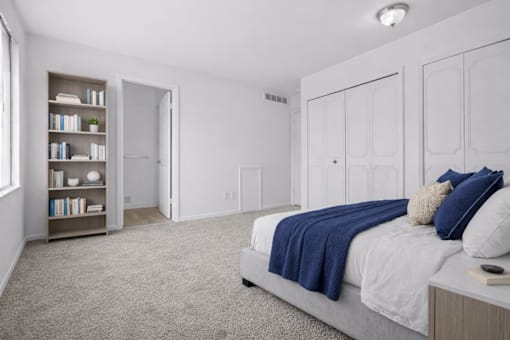 A bedroom with a bed, a bookshelf, and a window.