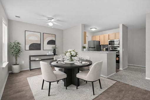 A modern dining room with a round table set for four.