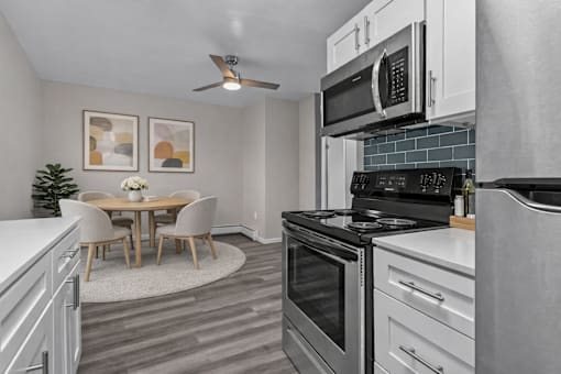 A modern kitchen with a dining table and chairs.