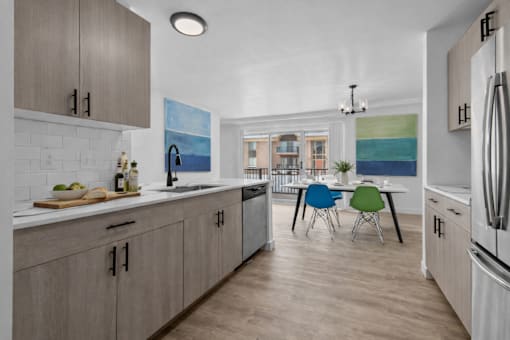 A kitchen with a table and chairs in the middle of the room.