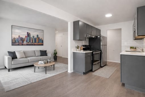 A modern kitchen with a cityscape painting on the wall.