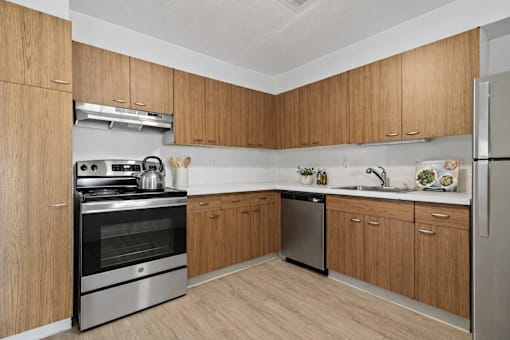 A kitchen with wooden cabinets and stainless steel appliances.