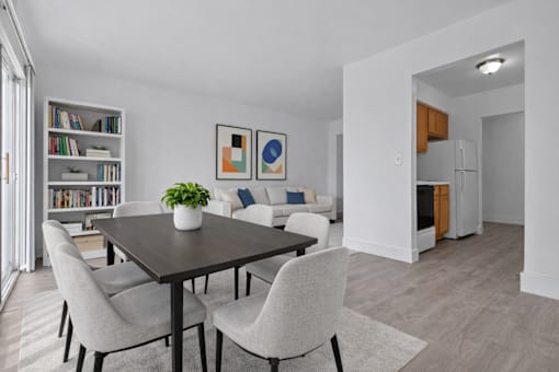 A dining room with a table and chairs.