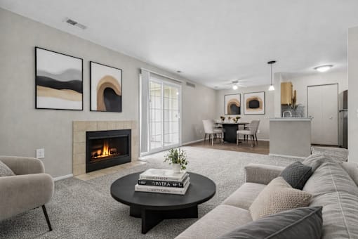 A living room with a fireplace and a painting on the wall.