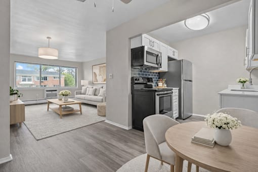 A modern kitchen with a dining table set for two.