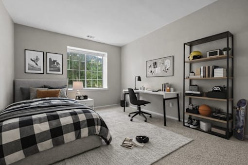 A bedroom with a bed, desk, chair, and bookshelf.