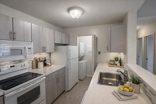 A modern kitchen with a stove, refrigerator, and sink.