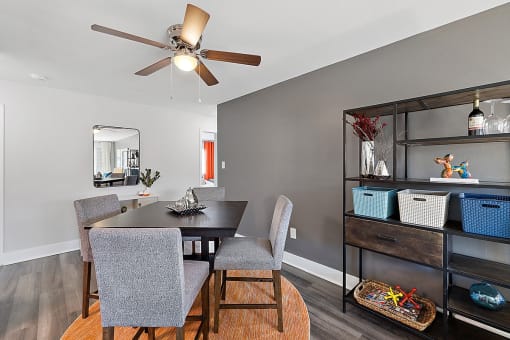 a dining room with a table and chairs and a ceiling fan