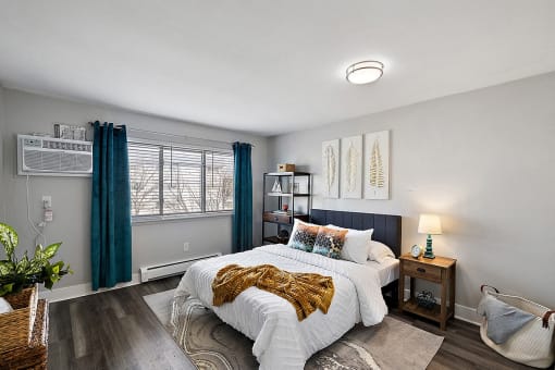 a bedroom with a bed and a window with blue curtains