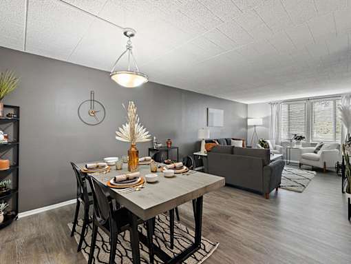 A dining room with a table set for a meal.