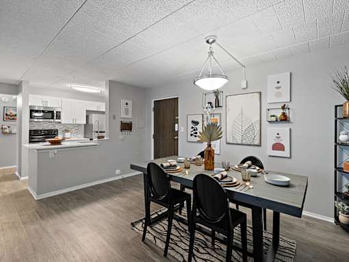 A dining room with a table set for four.