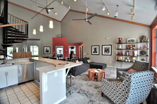 A kitchen with a dining table and chairs.