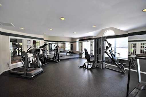 A spacious gym with a variety of equipment.