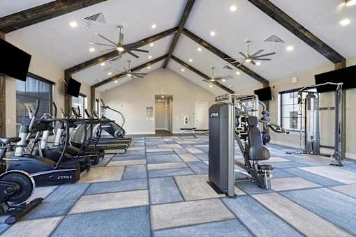 A spacious gym with a variety of exercise equipment.