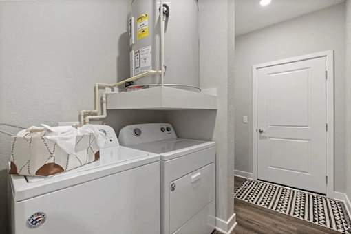 A white washing machine and dryer in a laundry room.