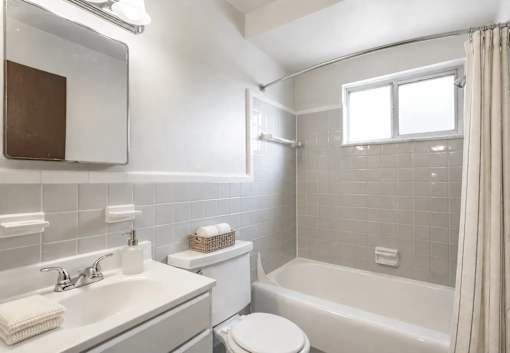 A white toilet sits next to a sink in a bathroom.