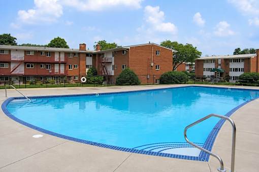 A swimming pool in front of a building.
