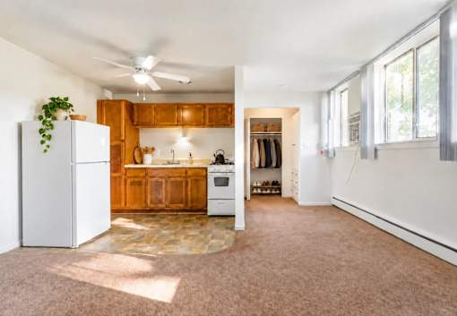 A kitchen with wooden cabinets and a white refrigerator.
