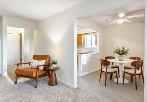 A living room with a brown chair and a white table.