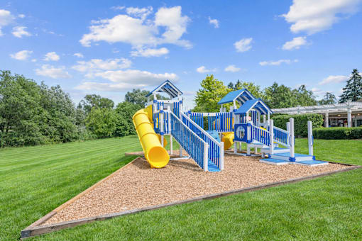 A playground with a blue and yellow slide.