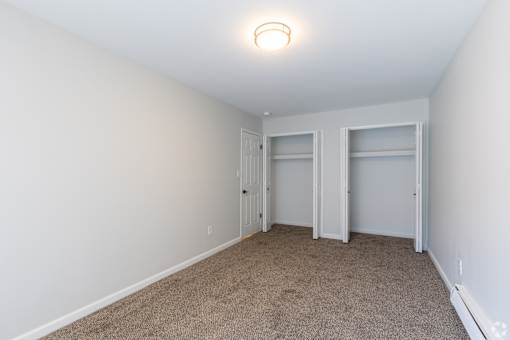 A room with white walls and carpeted floor. at The Park on 13 Apartments - Royal Oak, MI Apartments, Royal Oak