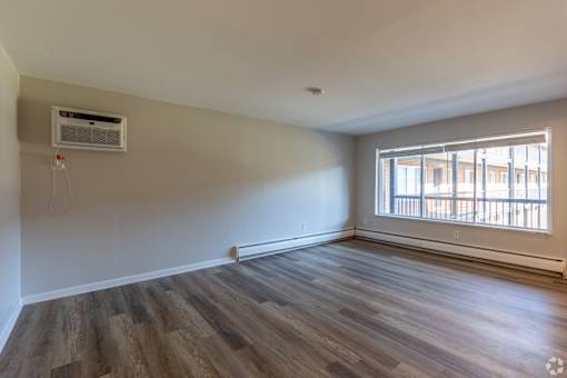 A room with a window and a wall-mounted air conditioner. at The Park on 13 Apartments - Royal Oak, MI Apartments, Michigan, 48073