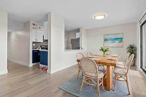 A dining room with a table set for four.
