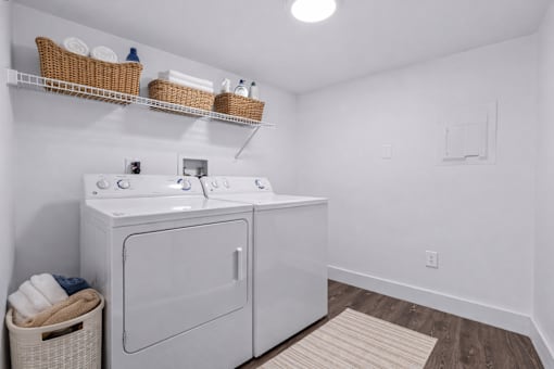 A white laundry room with a washer and dryer.