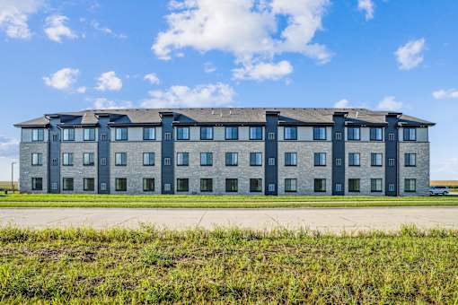 A large building with a flat roof and multiple windows.