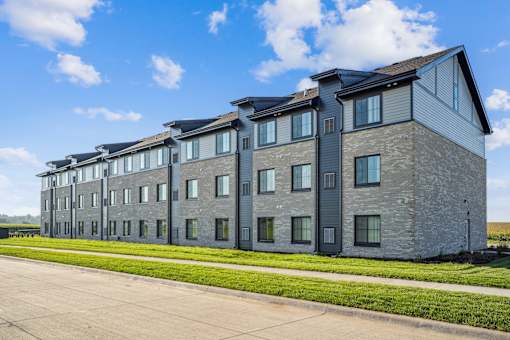 A large grey building with a lot of windows and doors.