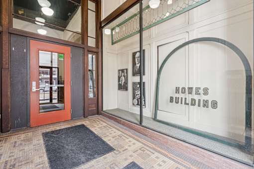 The front of the Howes Building is shown with a red door and a glass window.