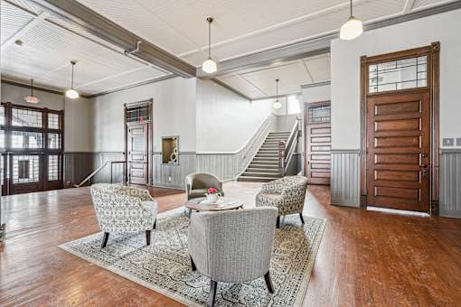 A living room with a grey sofa and a wooden door.