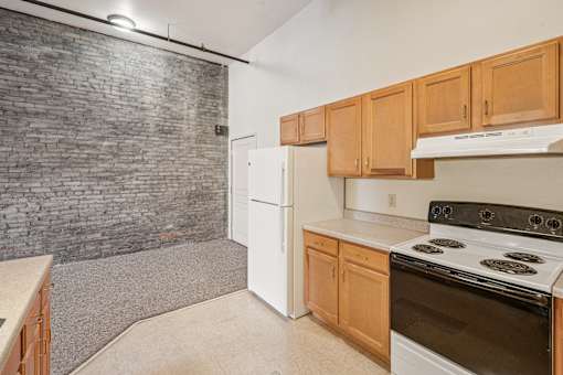 A kitchen with a white refrigerator and a white stove top oven.