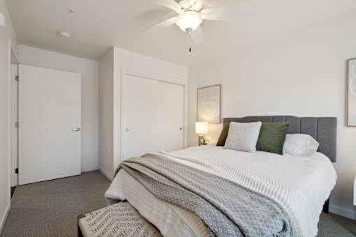 a bedroom with a large bed and a ceiling fan