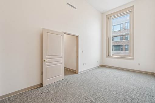 A room with a white door and a window.
