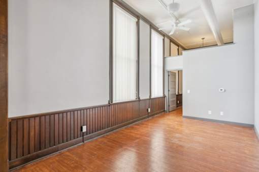 A room with wooden floors and a long window.