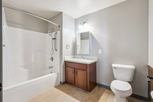 A white toilet sits next to a sink in a bathroom.
