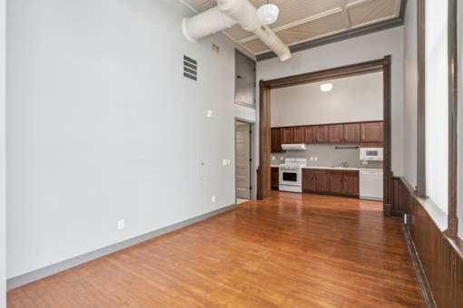 A kitchen with wooden floors and white walls.