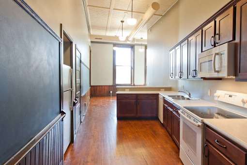 The kitchen in this one bedroom apartment has chalkboards that are original to the building.
