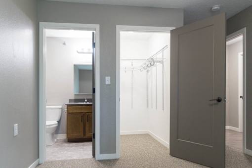 A bathroom with a toilet, sink, and a cabinet is shown.