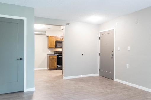 A kitchen area with a microwave, oven, and cabinets.