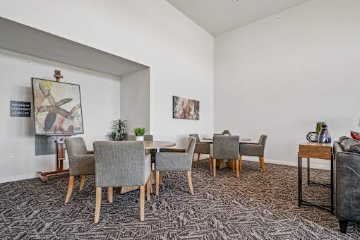 A dining room with a table and chairs.