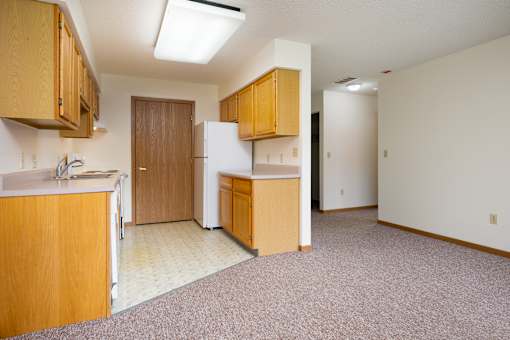 A kitchen with wooden cabinets and a white refrigerator.