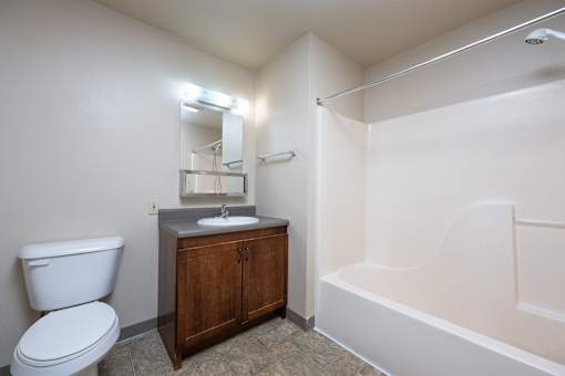 A white toilet sits next to a sink in a small bathroom.