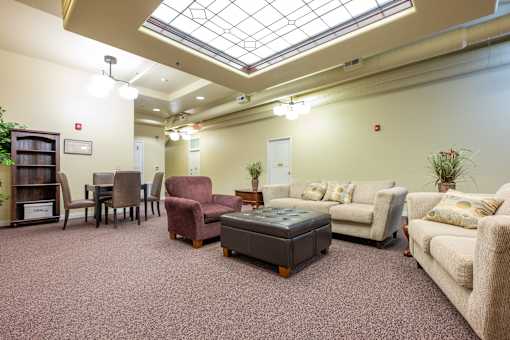 A living room with a variety of furniture including a couch, chairs, and a coffee table.