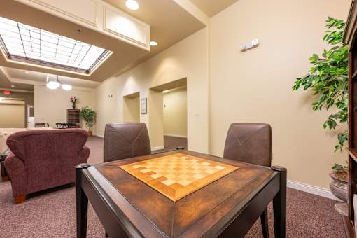 A room with a table and chairs and a ceiling light.