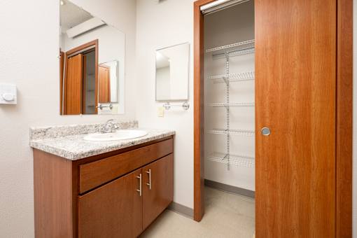 A bathroom with a sink, mirror, and medicine cabinet.
