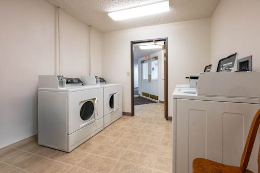 A room with a washer and dryer set up.